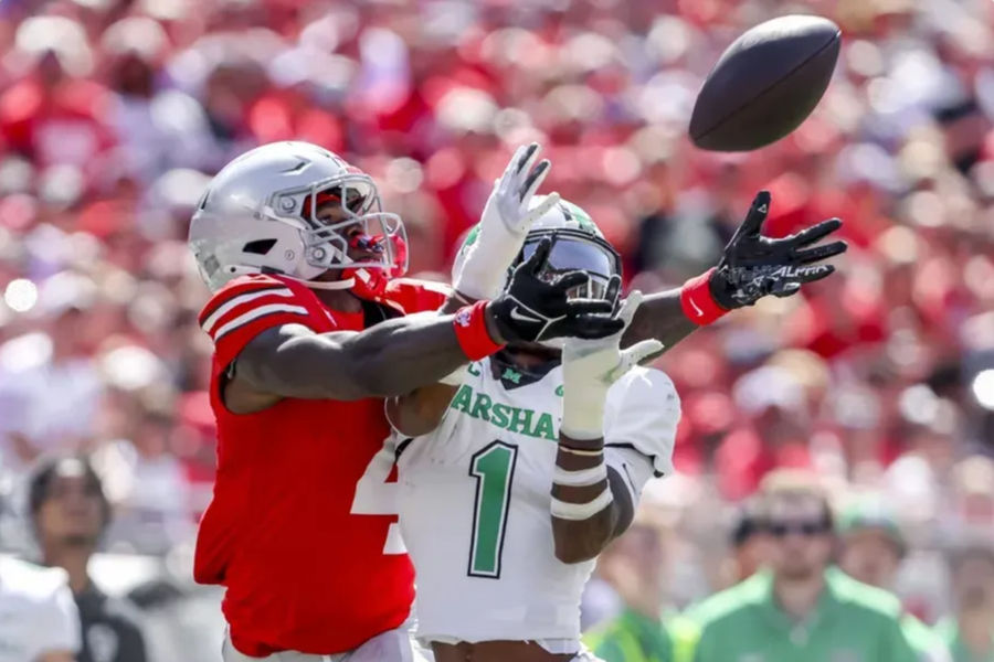 September 21, 2024; Columbus, Ohio, USA; Ohio State Buckeye's wide recipient Jeremiah Smith (4) goes for the ball with Marshall Thundering Herd Defensive Back Josh Moten (1) during the first quarter at Ohio Stadium. Mandatory Credit: Joseph Maiorana-Imagn images