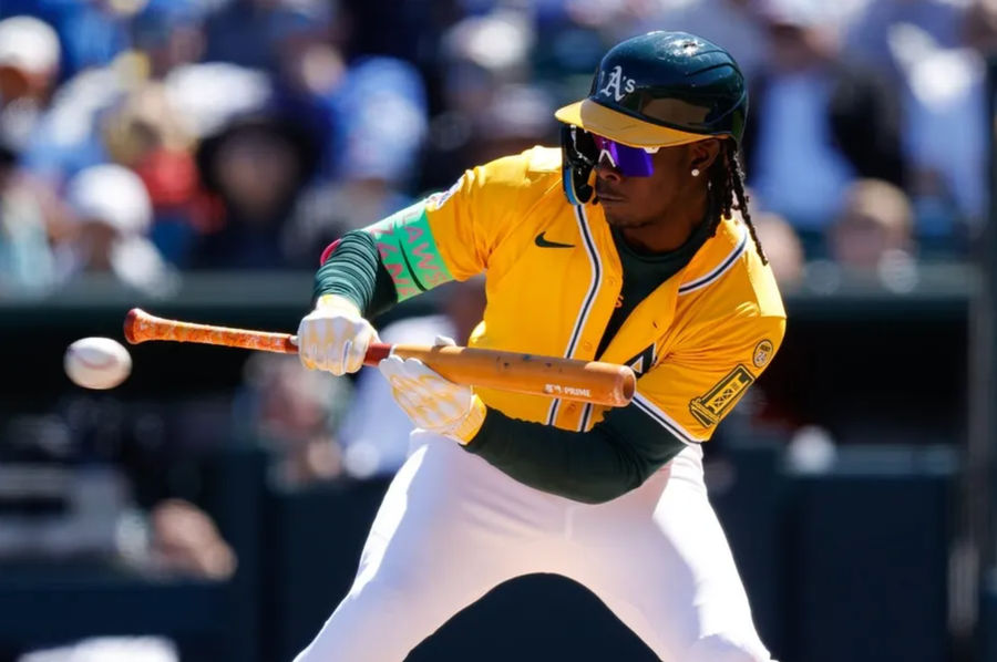 April 2, 2025; West Sacramento, California, USA; Athletics Outfielder Lawrence Butler (4) puts down a bundle during the third round against Chicago Cubs in Sutter Health Park. Mandatory Credit: Sergio Estrada-Imagn images