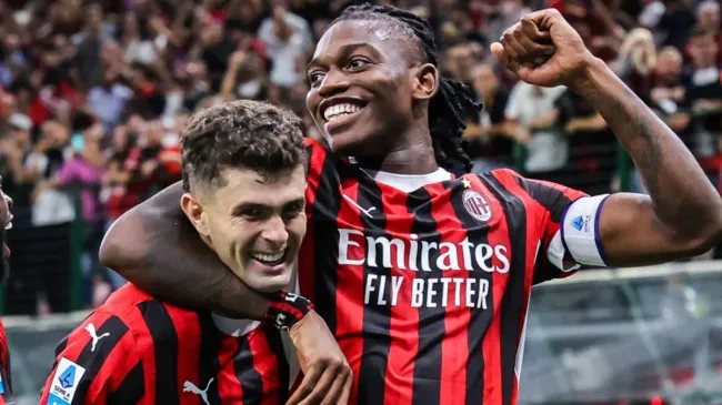 Christian Pulisic and Rafael Leao celebrate.